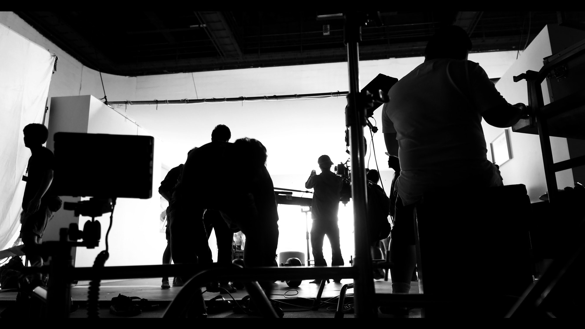 Silhoutte images of video production and lighting set for filming which movie crew team working and